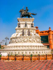 white concrete statue of man riding horse