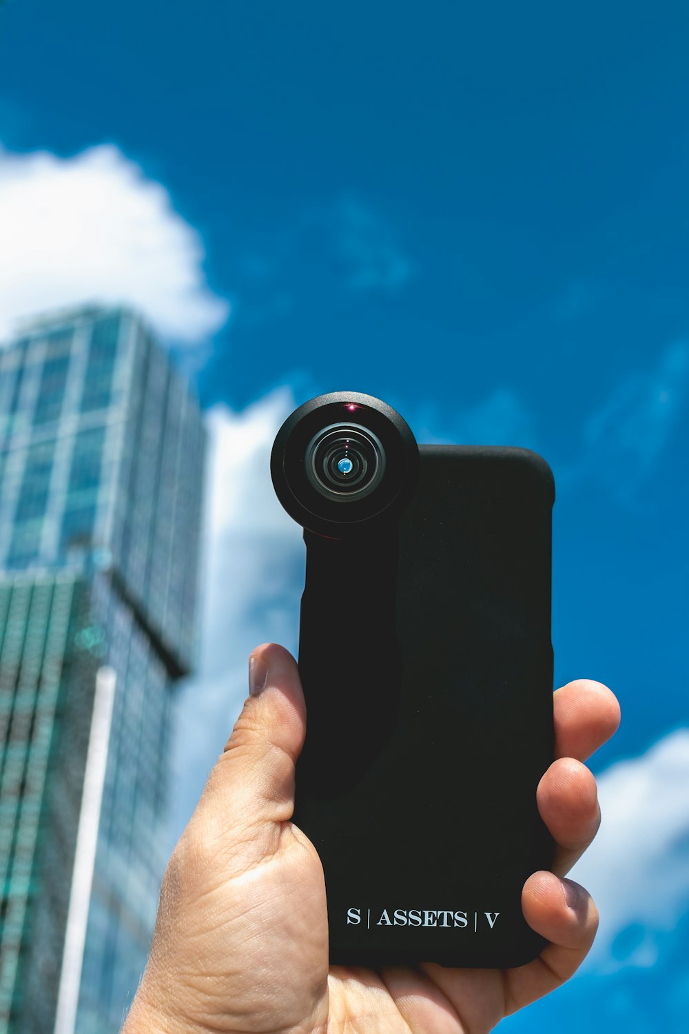 person holding black camera lens