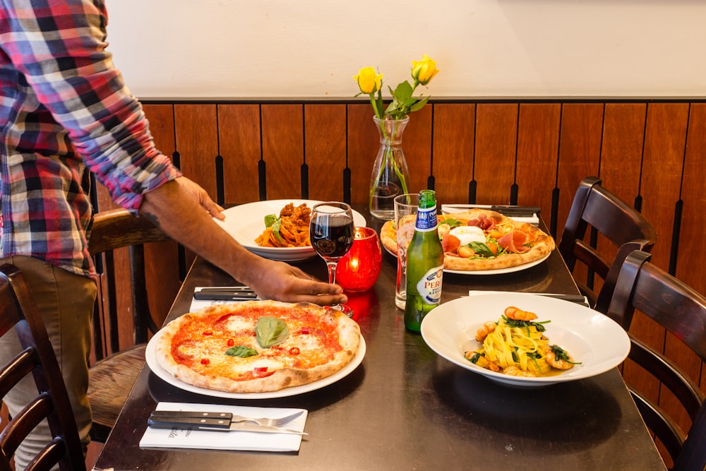 person holding plate with pizza