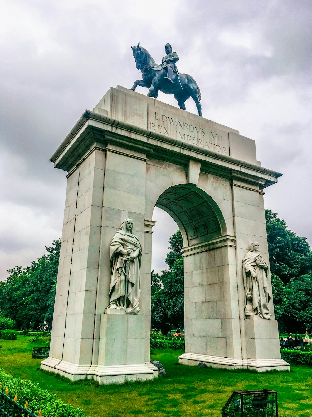 man riding horse statue under white clouds during daytime