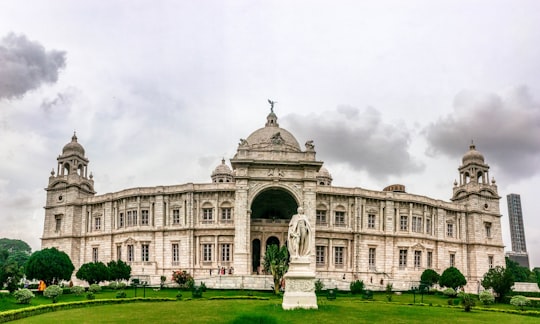 white concrete building under white sky during daytime in Victoria Memorial India