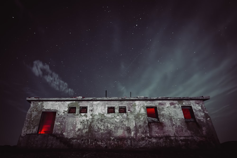 white and red house under starry night