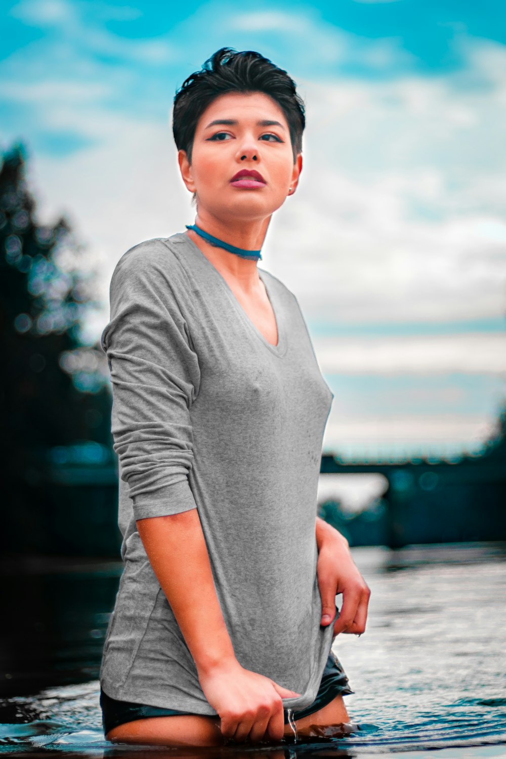 woman in gray long sleeve shirt standing on beach during daytime