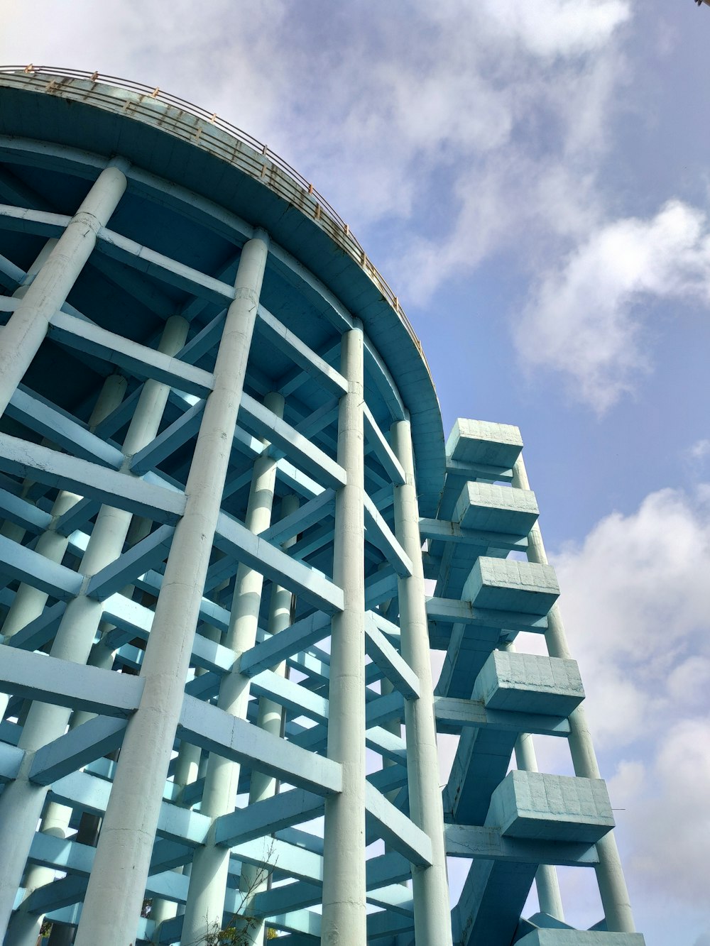 white concrete building under white clouds during daytime