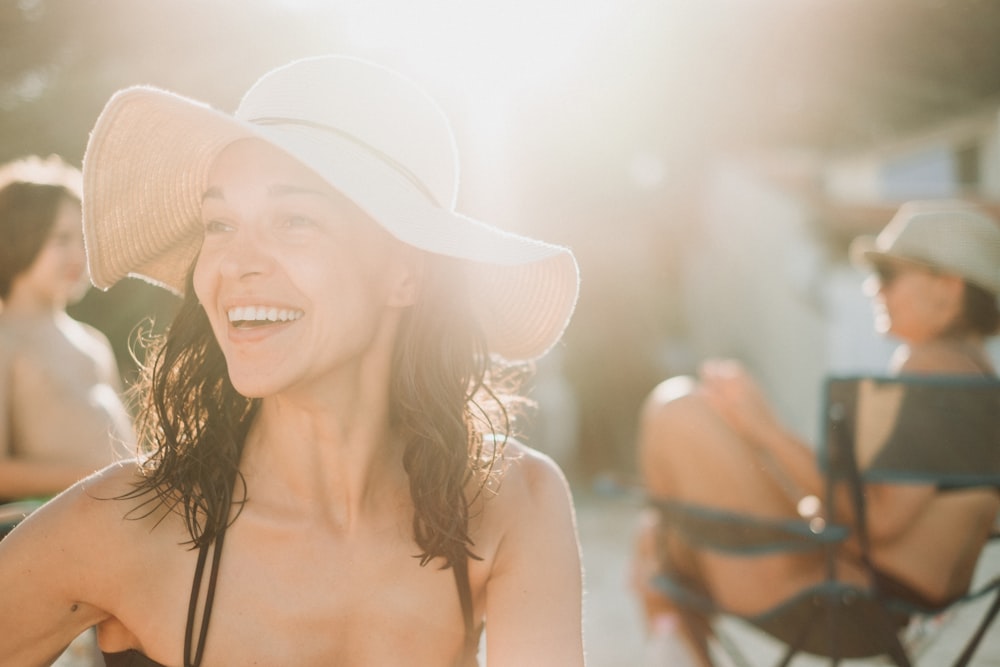 smiling woman in white sun hat