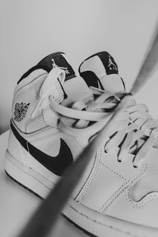 Close-up black and white shot of running shoes lined up, ready for action.