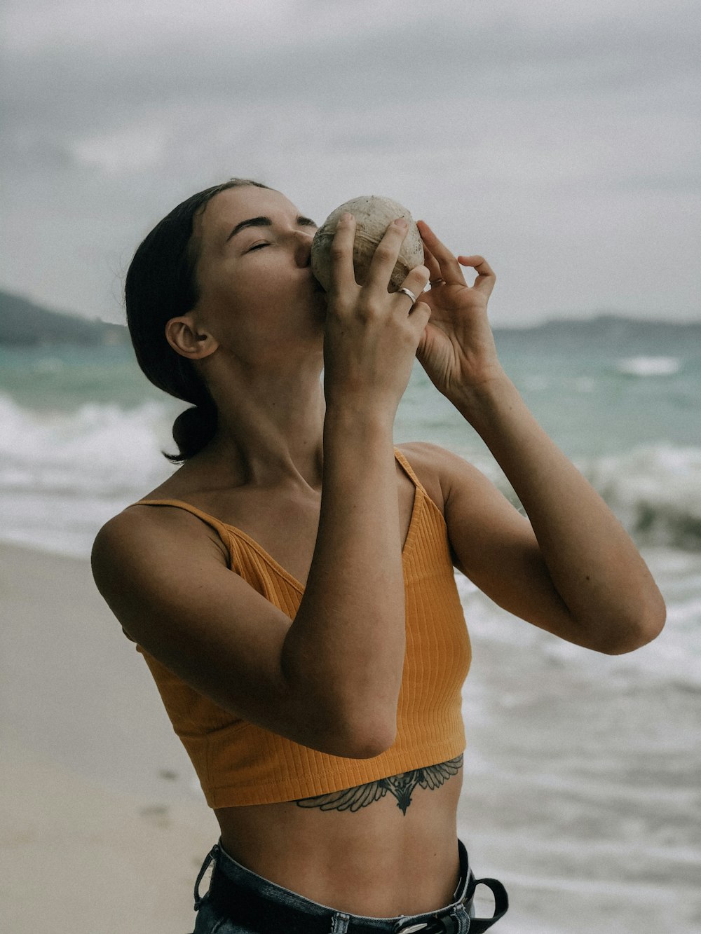 woman in yellow tank top kissing mans cheek