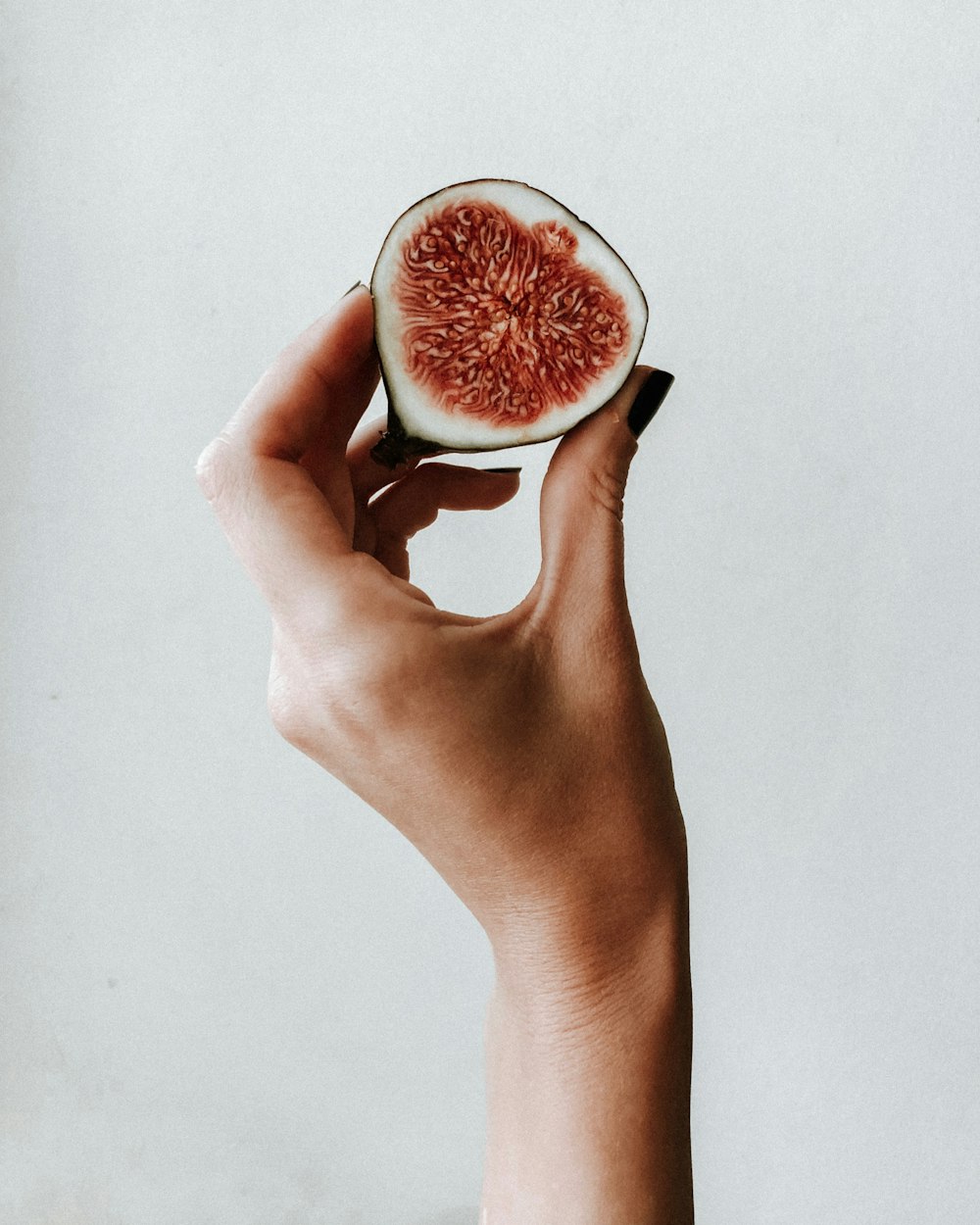 person holding sliced of watermelon