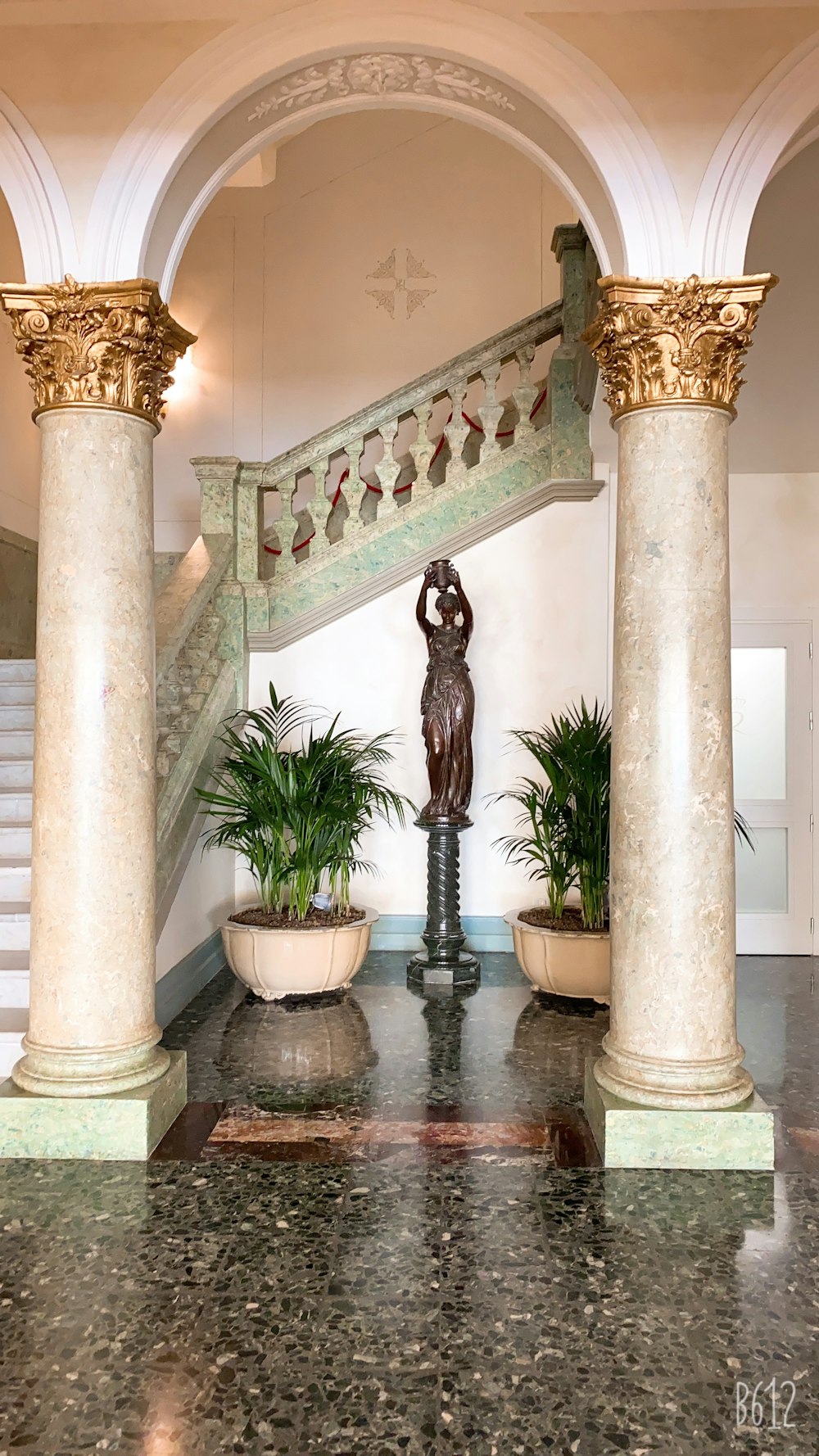 statue of man on white concrete column