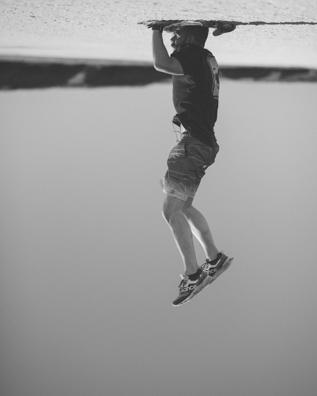 man in black t-shirt and white shorts jumping on mid air