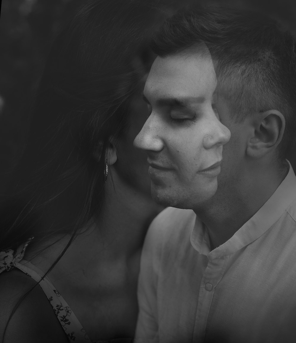 man and woman in grayscale photography