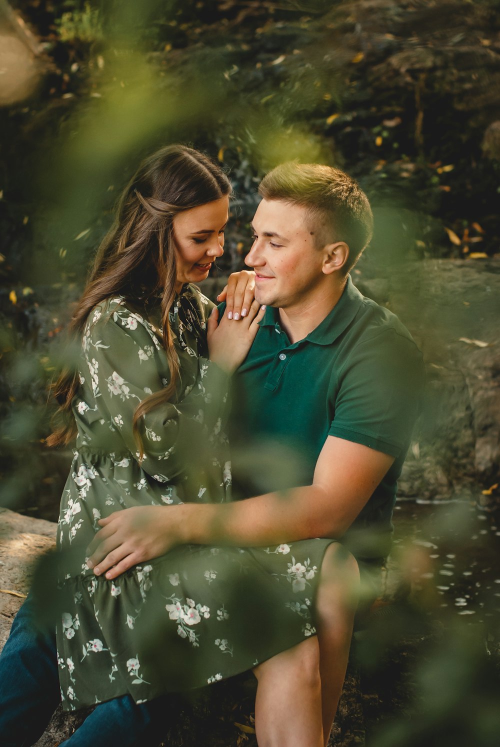 man and woman kissing on river during daytime