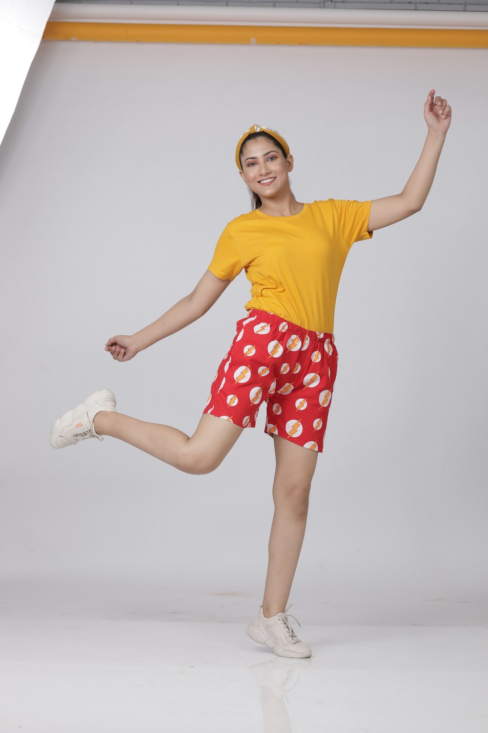 woman in yellow shirt and red and white floral skirt