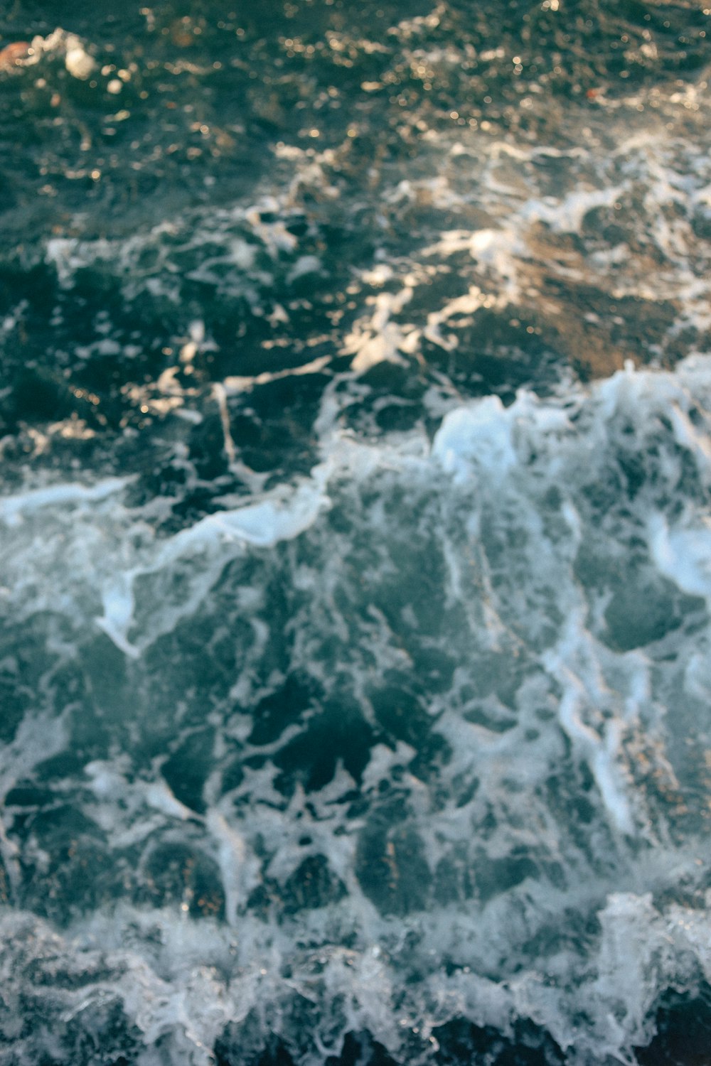 water waves hitting rocks during daytime