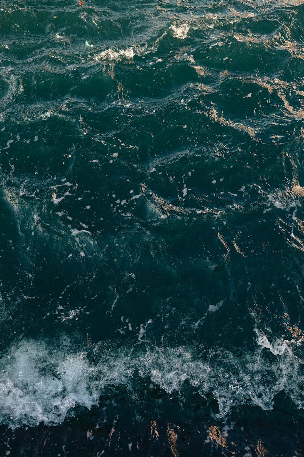 water waves on blue body of water during daytime