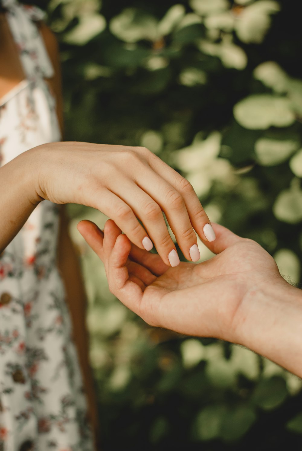 persons hand with gold ring