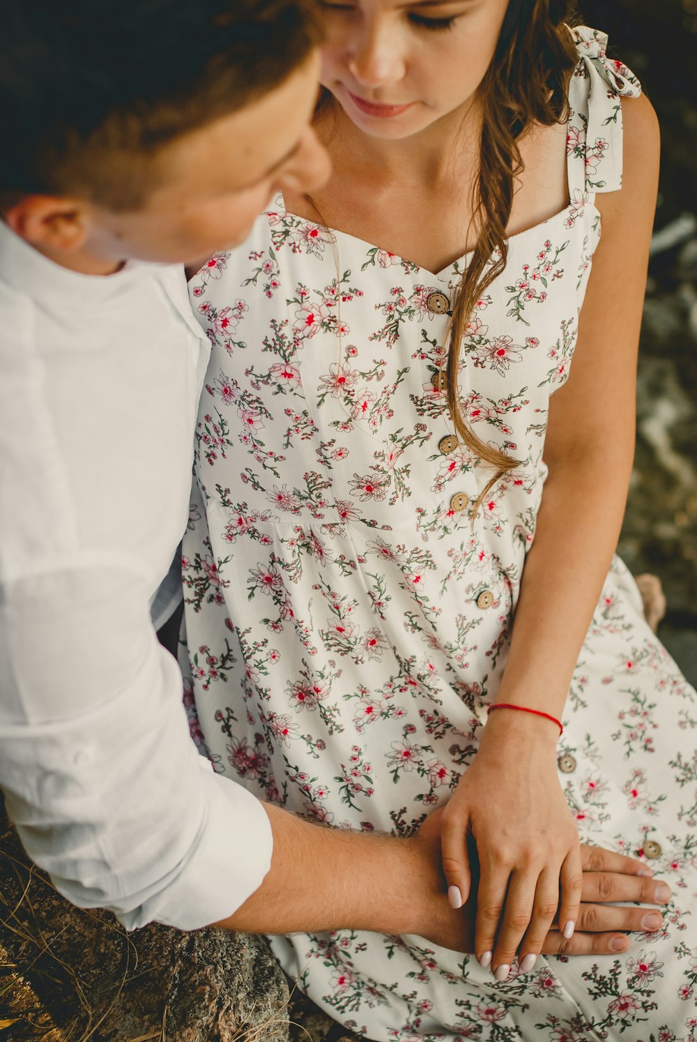 woman in white and red floral dress