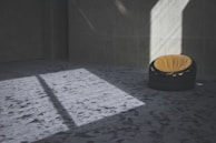 A bright, modern carpet with geometric designs laid out in a minimalist room.