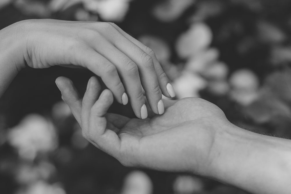 grayscale photo of persons hand