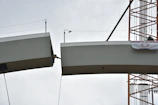 Engineer inspecting structural beams on a construction site in Portugal.