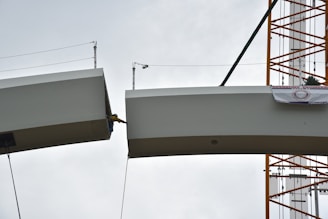 Image of a skilled worker inspecting steel beams at a construction site.