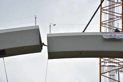 Engineer inspecting structural beams on a construction site in Portugal.