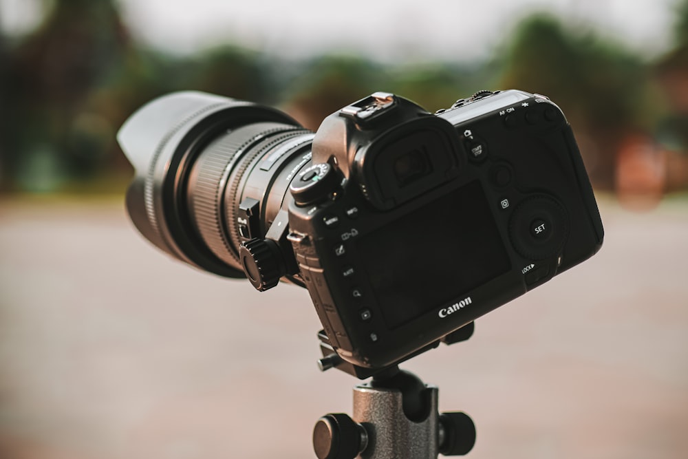 black dslr camera on brown wooden table