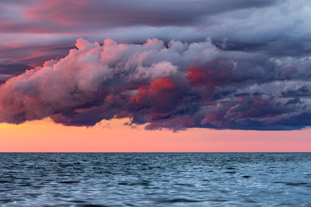 body of water under cloudy sky during daytime