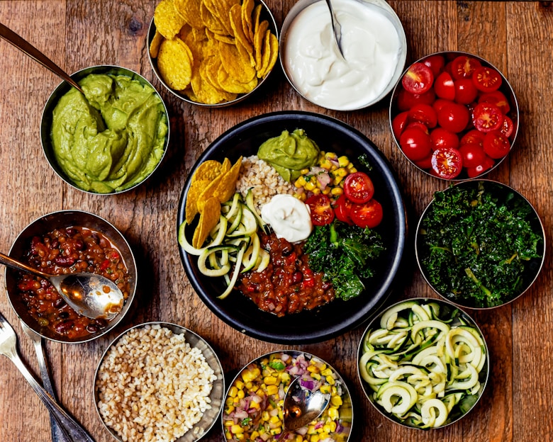 Close-up of healthy snack bowls with fresh ingredients on a wooden table