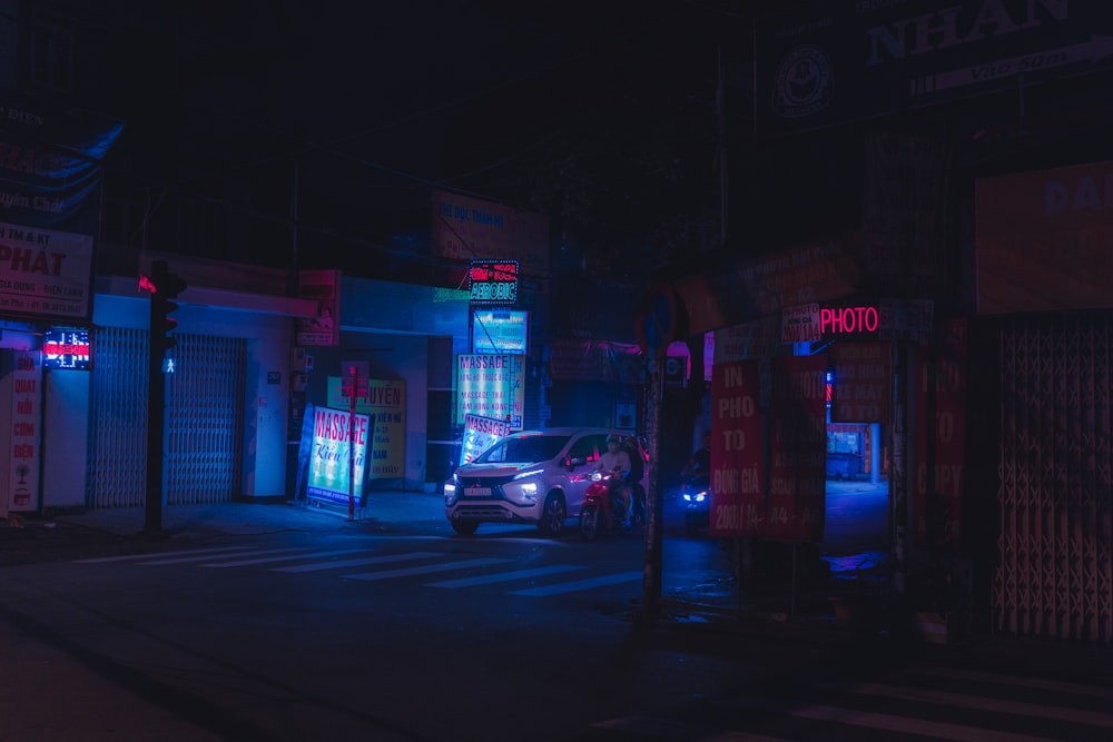 cars parked in front of store during night time