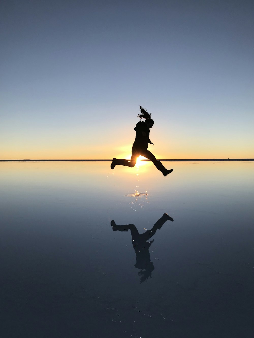 silhouette of person hanging on rope