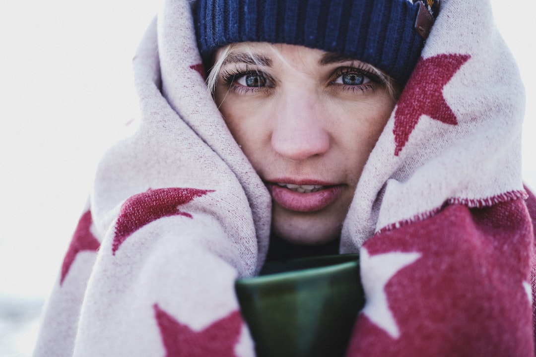 person in black knit cap and red and white hoodie