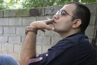 A relaxed person smiling outdoors, symbolizing freedom from smoking.