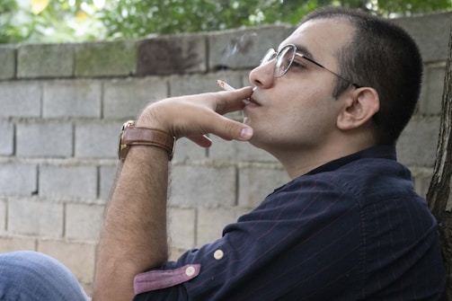 A relaxed individual taking a break outside, enjoying fresh air during work hours.