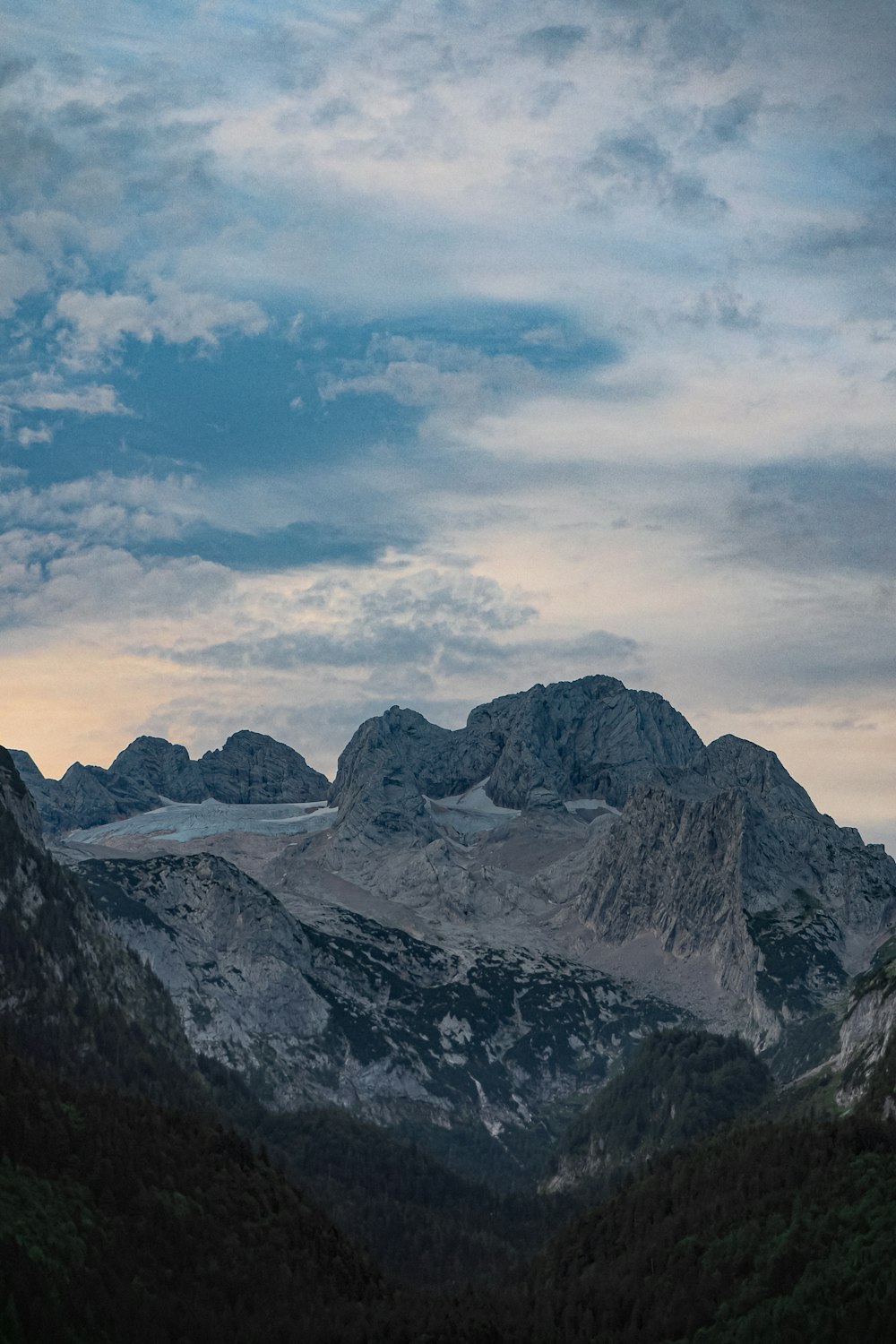 snow covered mountain under cloudy sky during daytime