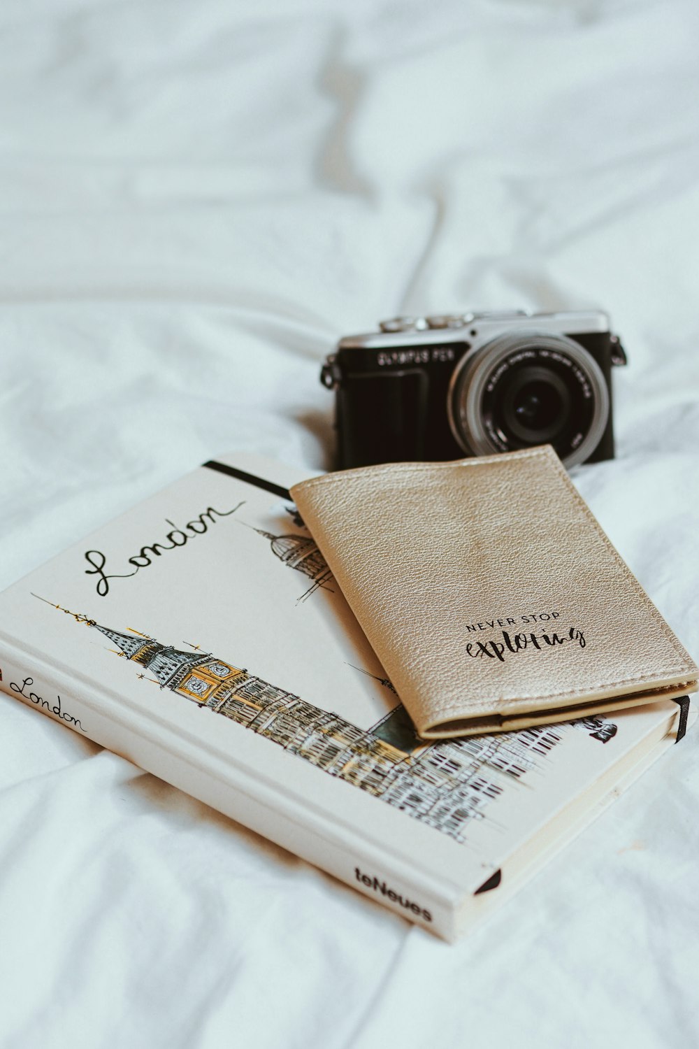 black and silver camera on book