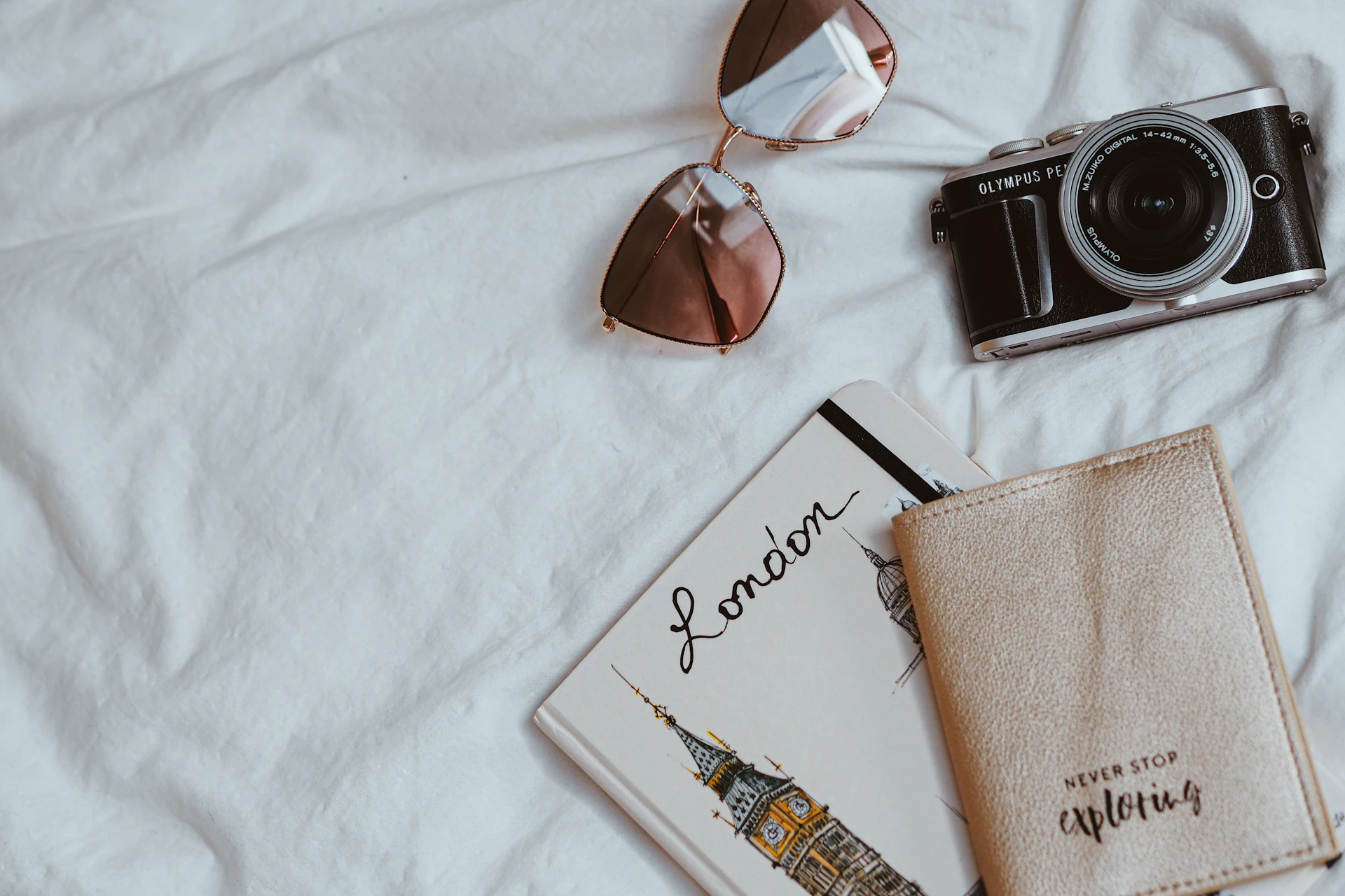 brown sunglasses beside black and silver camera