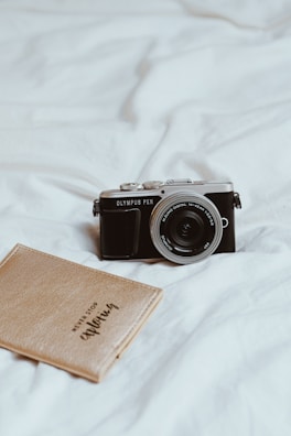 A close-up of a vintage camera resting on a leather-bound journal, capturing life’s little stories.