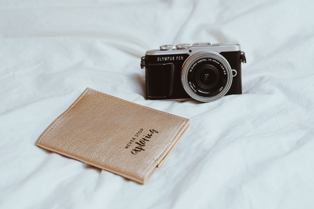 black and silver camera on white textile