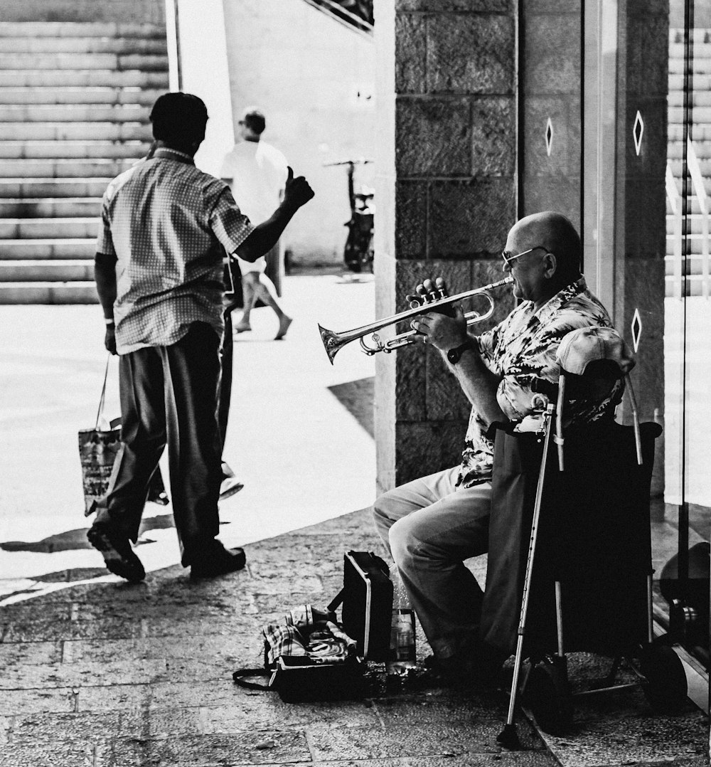 man playing guitar beside man playing guitar