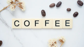 A flat lay of different brewviva coffee packs surrounded by coffee beans and tropical flowers.