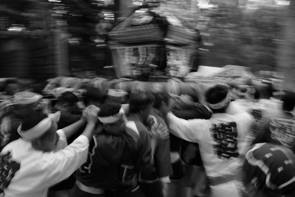 a crowd of people standing around a statue