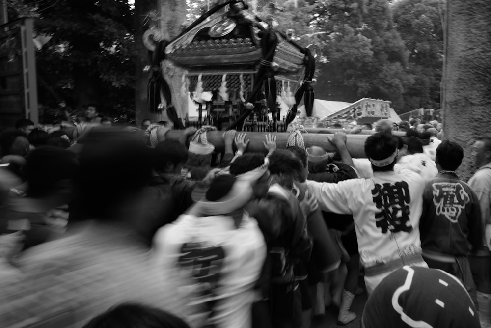 a crowd of people standing around a statue