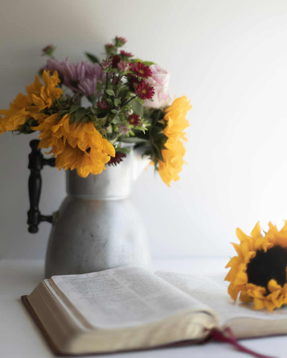 yellow and white flowers in white ceramic vase