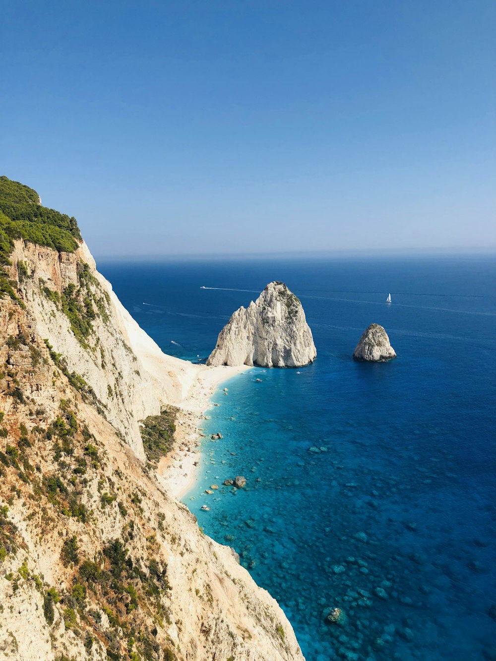 brown rock formation on sea during daytime