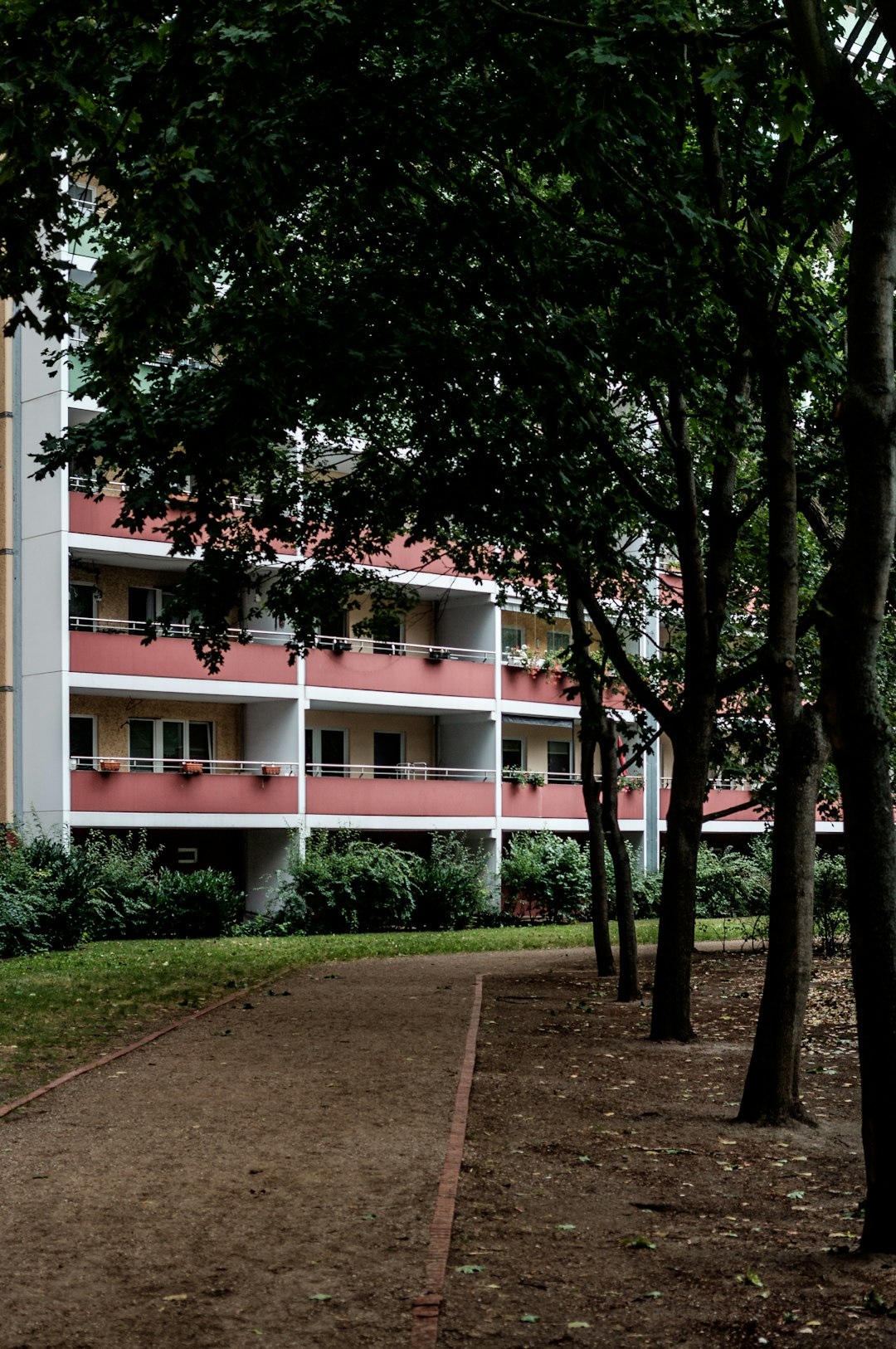 white concrete building near green trees during daytime