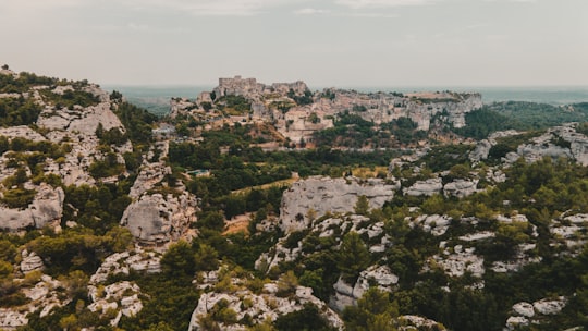 green and brown mountain under white clouds during daytime in Les Baux-de-Provence France