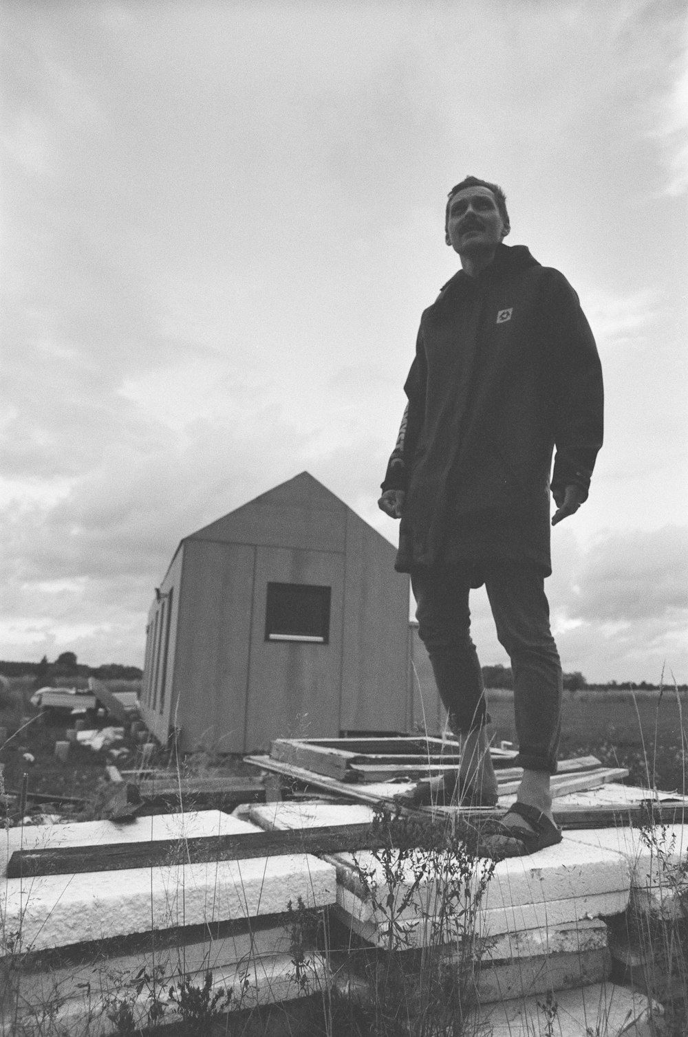 man in black jacket standing on snow covered ground