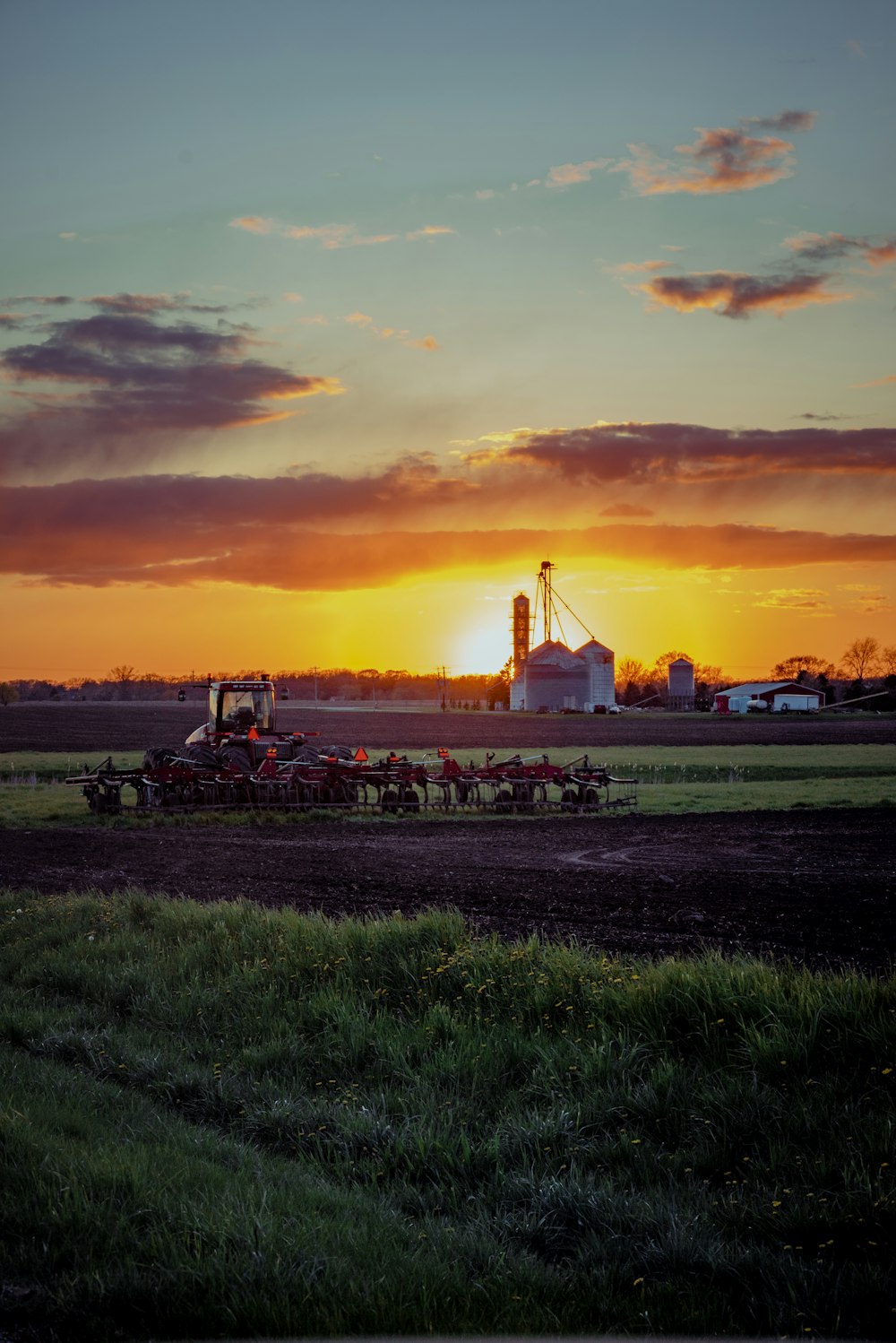 green grass field during sunset