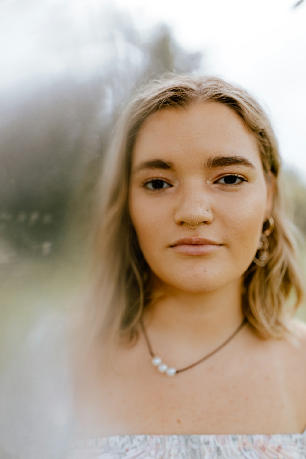 woman in silver necklace and silver earrings